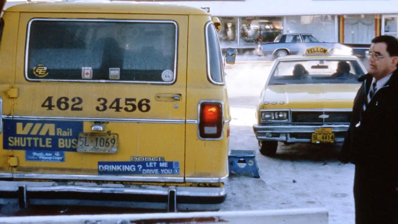 A licensed Florida contractor checking documents on a phone beside a work van in a Tampa Bay neighbourhood